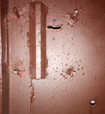 Вид места демонтированного сувальдного замка на металлической двери до замены